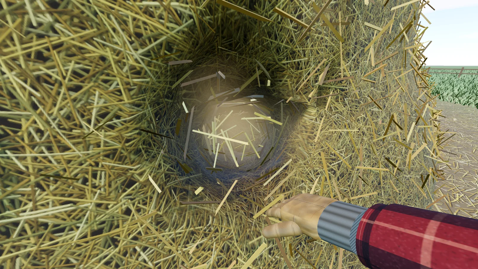 Gloved hand pulling a hole into the side of the haystack